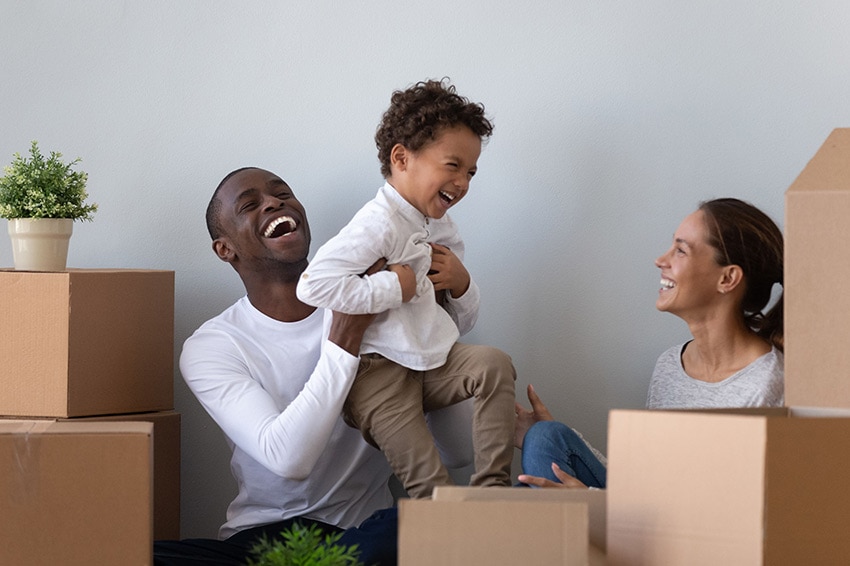 Family unpacking boxed in new home