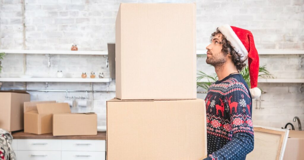Man moving into Raleigh Property with holiday hat